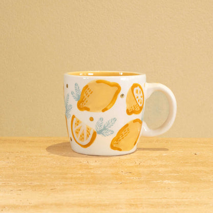 Personalized handmade ceramic mug with gold-plated letter M and floral design.