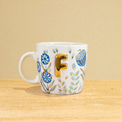 Personalized handmade ceramic mug with gold-plated letter F and floral design.