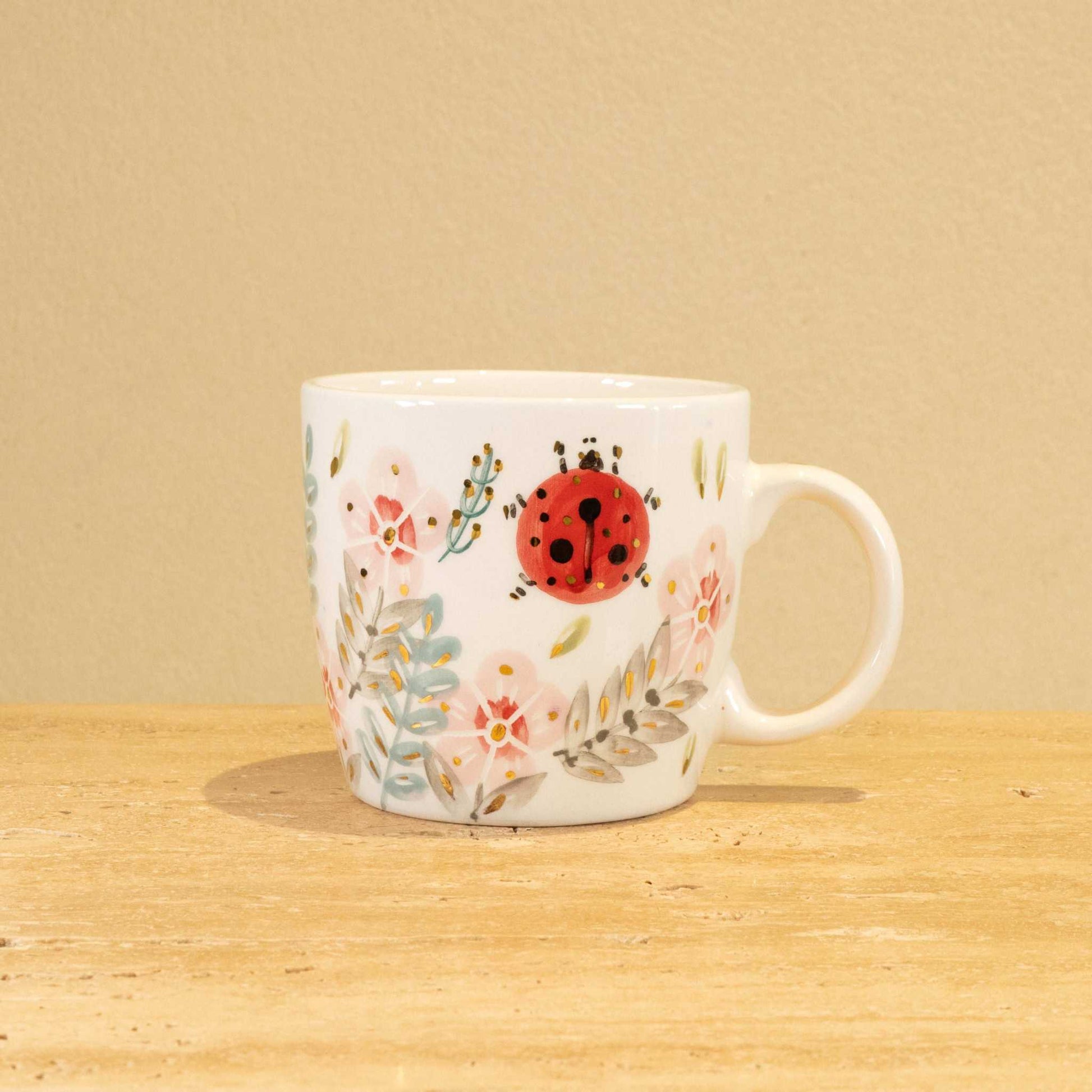 Custom handmade ceramic mug with gold-plated initial Z and floral design.