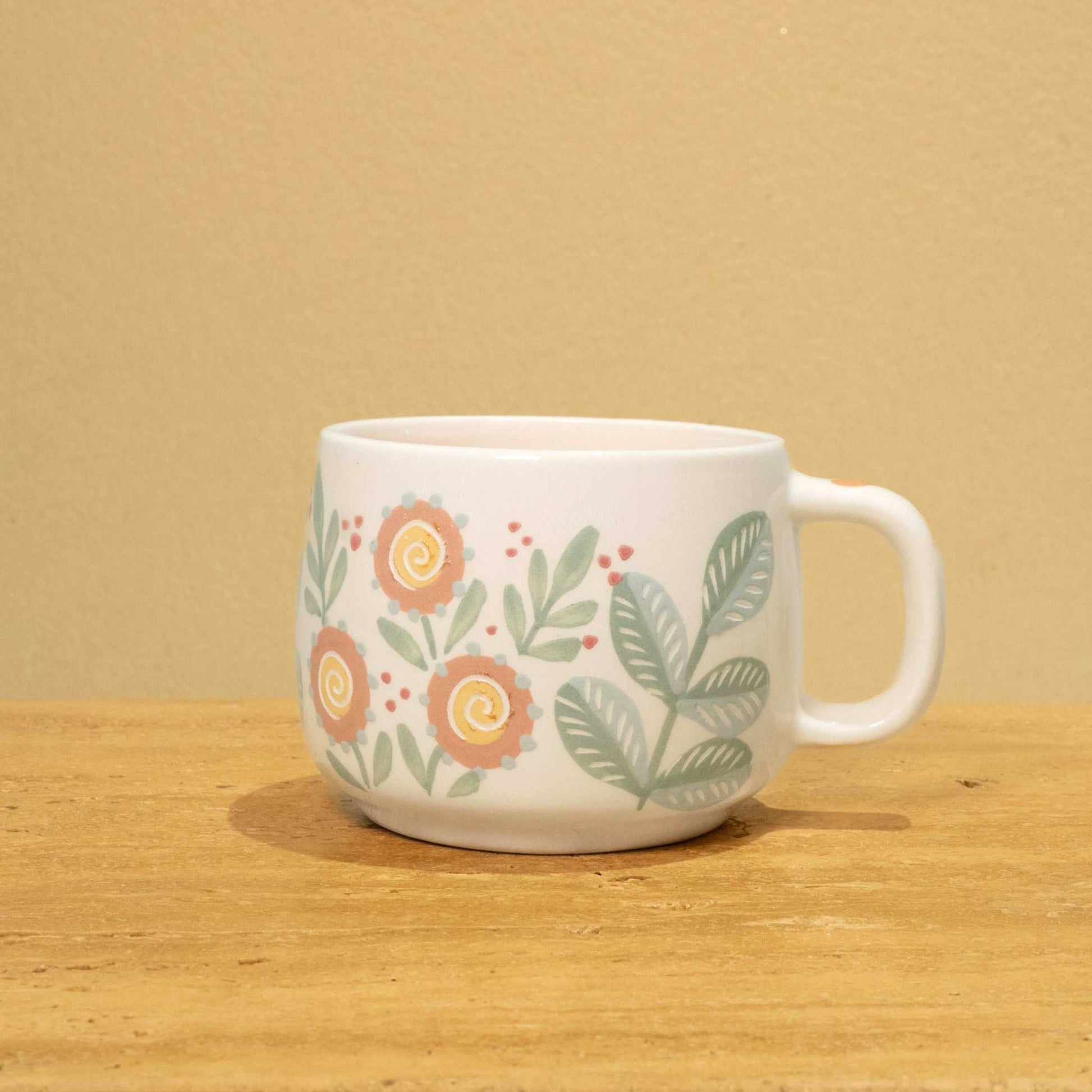 Personalized gold Arabic monogram ceramic mug with floral design, "Best Son in the World" theme.