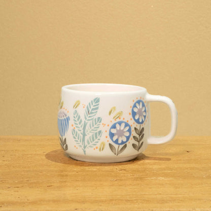 Handmade ceramic mug with gold Arabic monogram "Best Dad in the World" and floral design.
