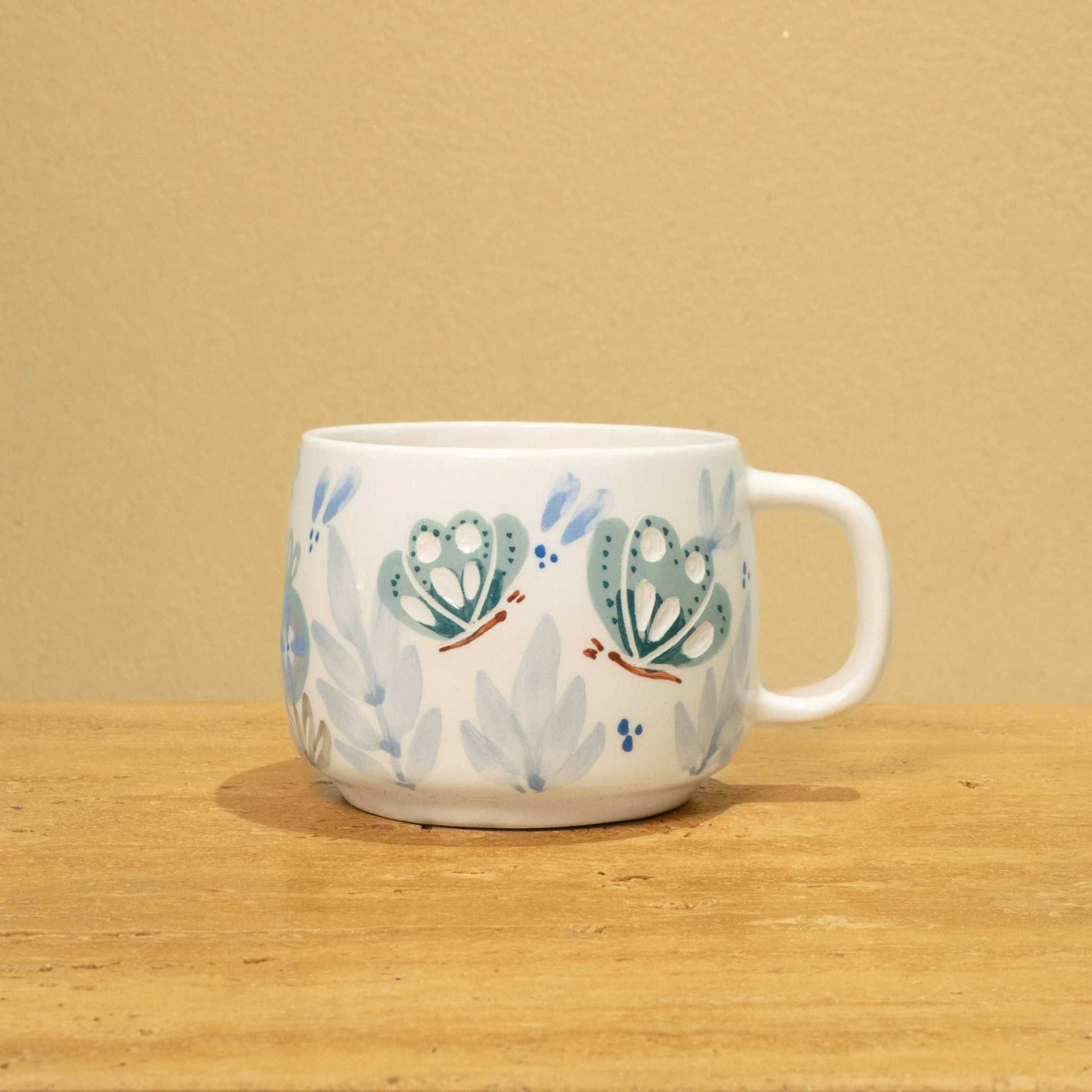 Personalized gold Arabic monogram ceramic mug with floral design, "Best Brother in the World".
