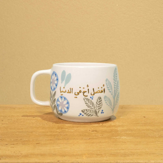 Handmade ceramic mug with gold-plated Arabic "Best Brother in the World" and floral design.