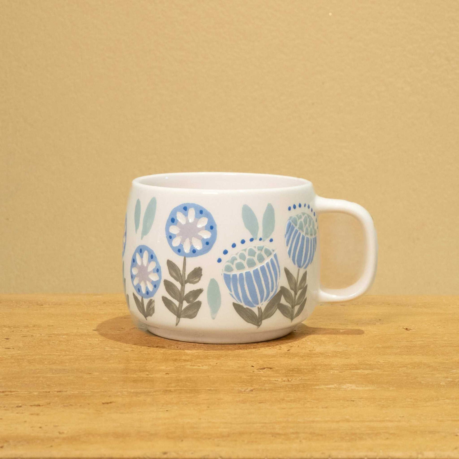 Exquisite ceramic mug with gold Arabic monogram "Best Brother in the World" and floral design.