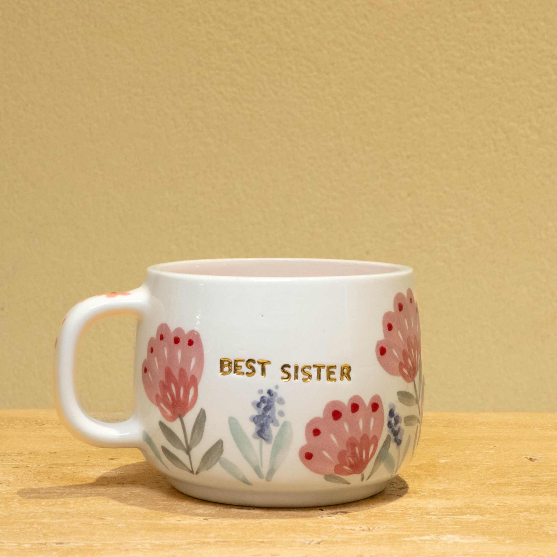 Handmade gold plated cup with "Best Sister" message and floral design.
