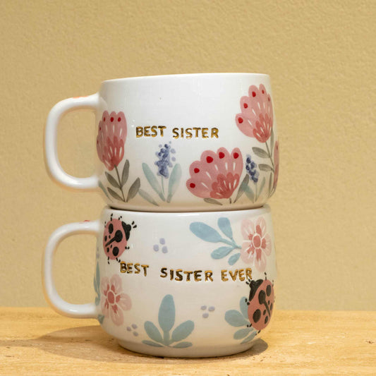HANDMADE GOLD PLATED cup with floral design reading 'Best Sister'.