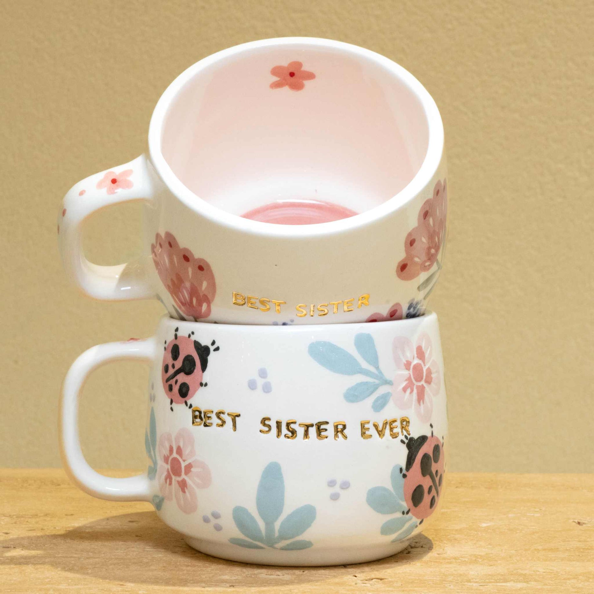 Handmade gold plated cup with "Best Sister" design, featuring unique floral patterns.