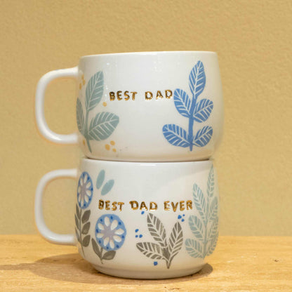 Personalized ceramic mug with gold "BEST DAD" monogram and floral design.