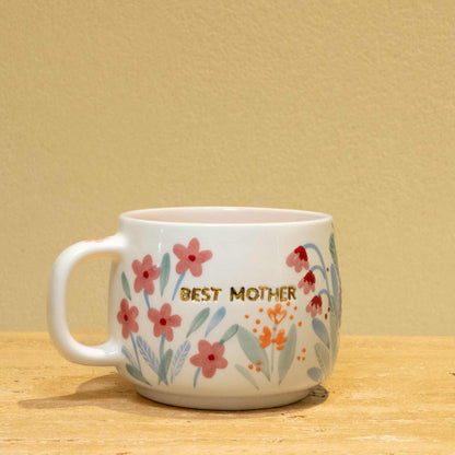 Personalized ceramic mug with gold "Best Mother" and floral design.