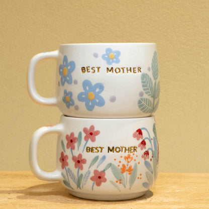 Personalized ceramic mug with gold "BEST MOTHER" and floral design.
