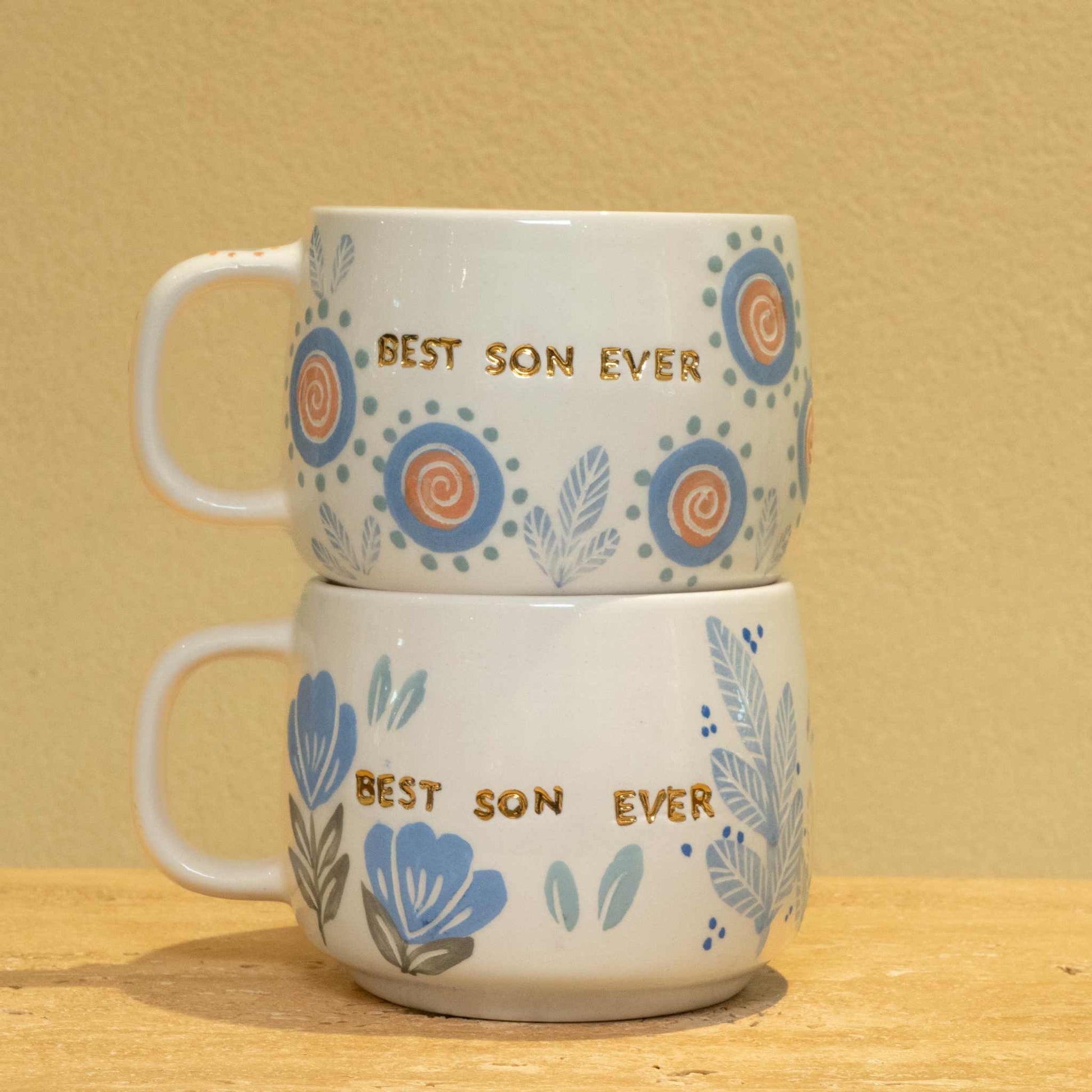 Personalized ceramic mug with "Best Son Ever" gold monogram and floral design.