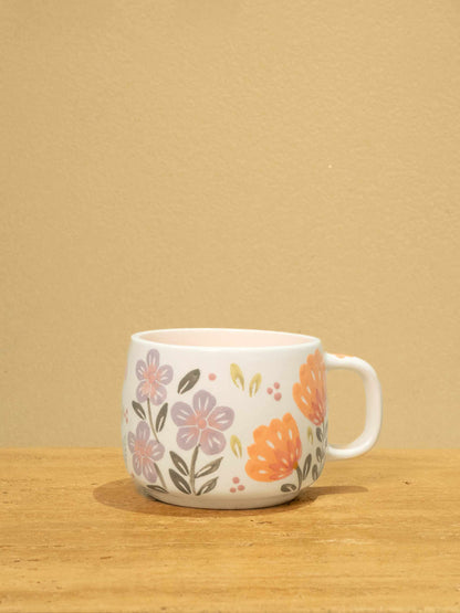Handmade ceramic mug with gold Arabic monogram "Best Sister in the World" and unique floral design.