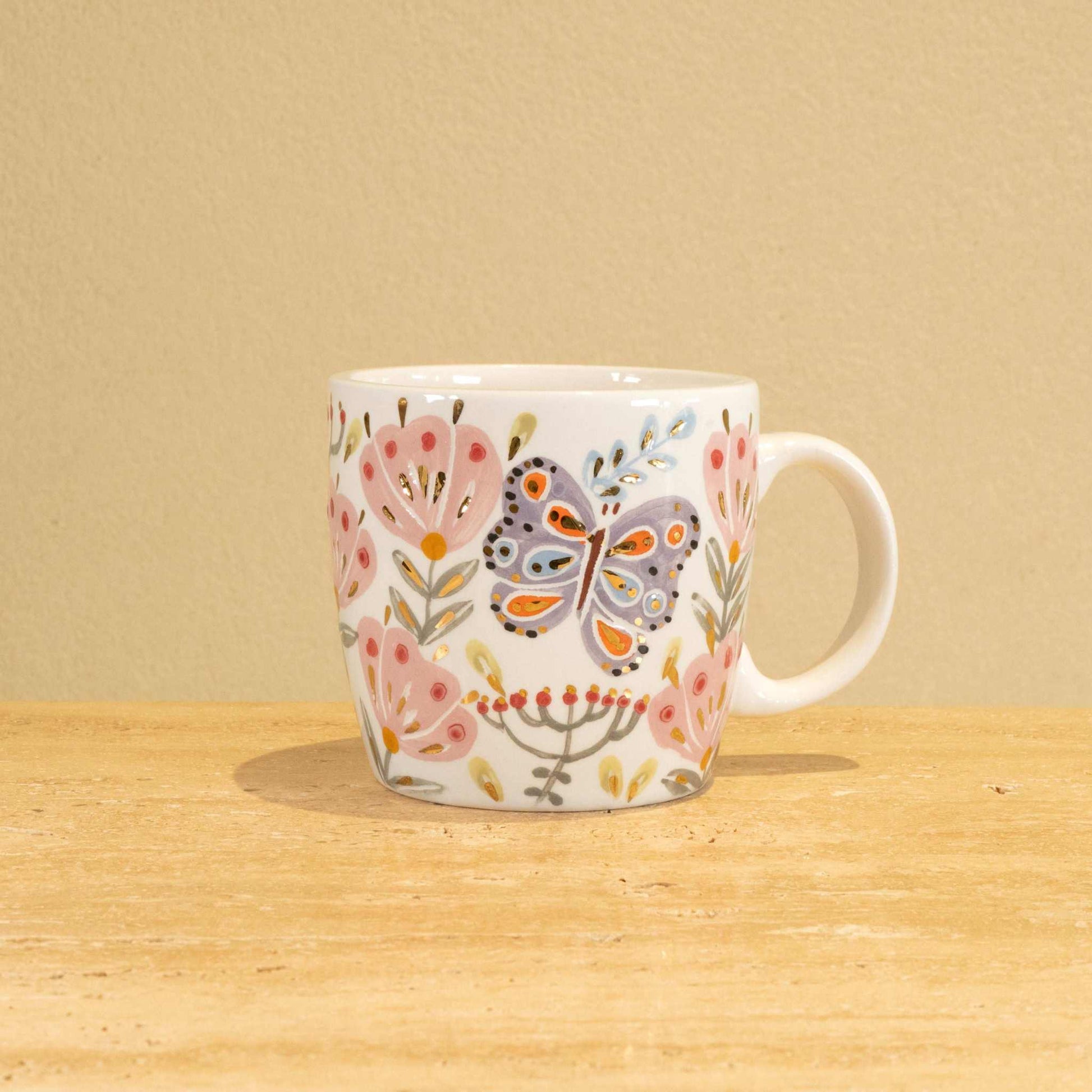 Custom handmade ceramic mug with gold-plated initial "R" and floral design.
