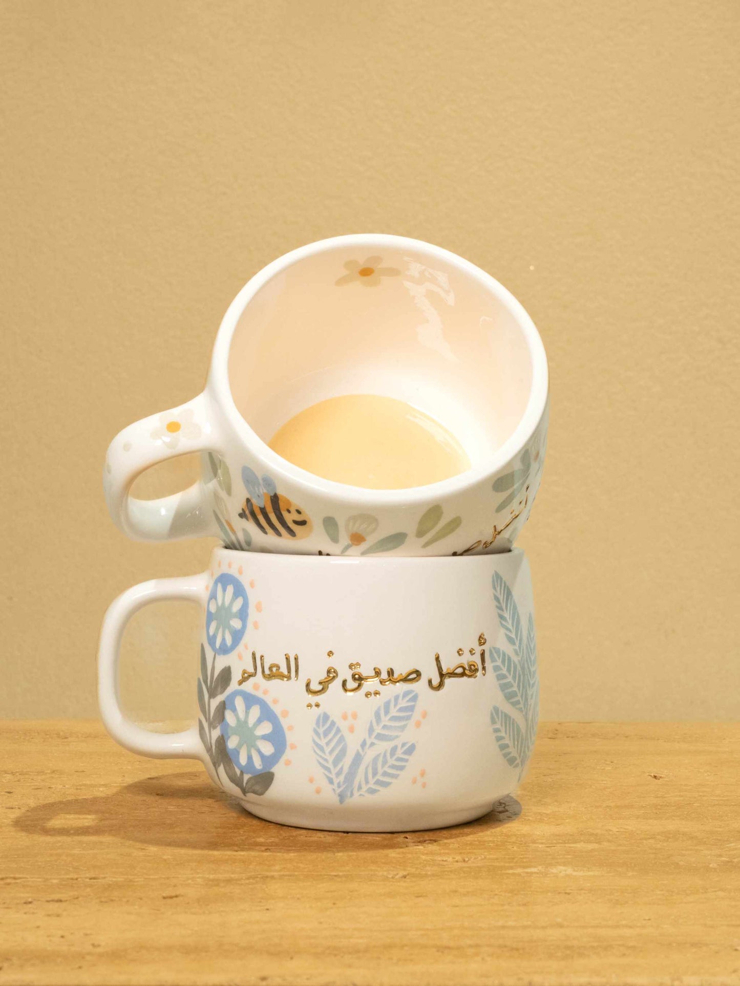 Personalized gold Arabic monogram ceramic mug with floral design, "Best Male Friend" gift.