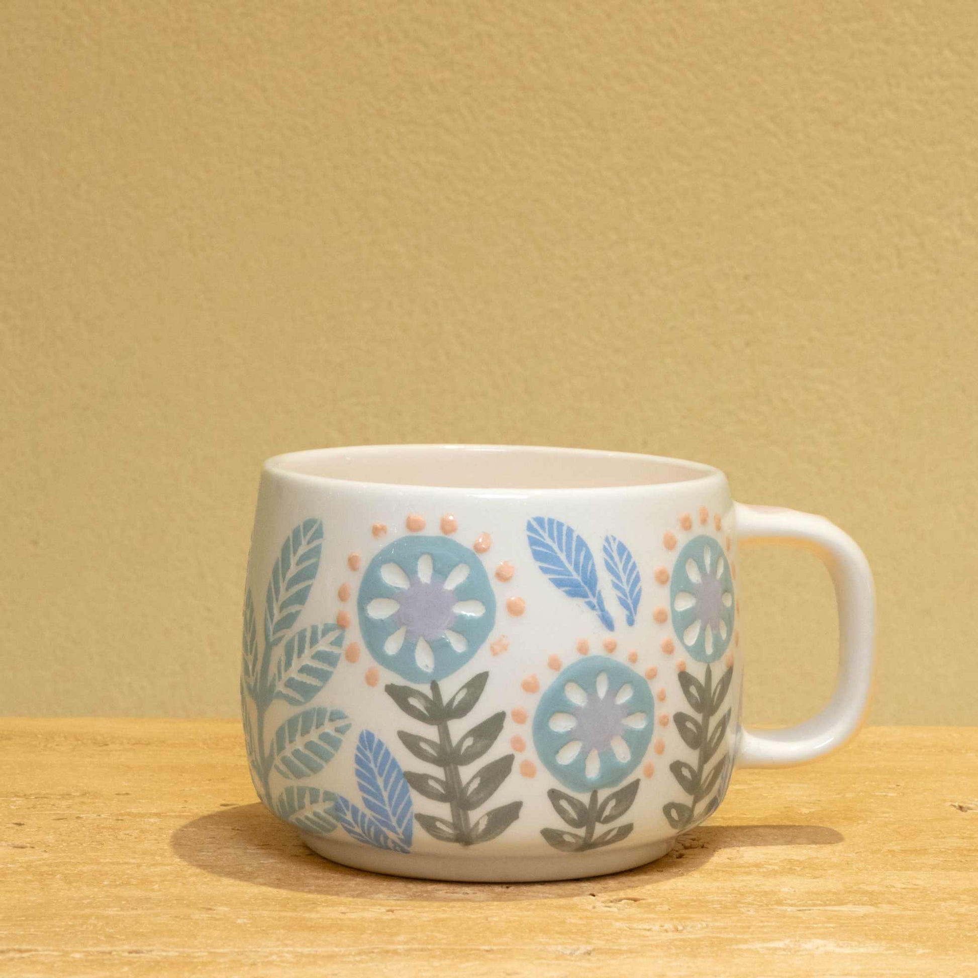 Personalized gold monogram ceramic mug with floral design and "Best Friend Ever" lettering.