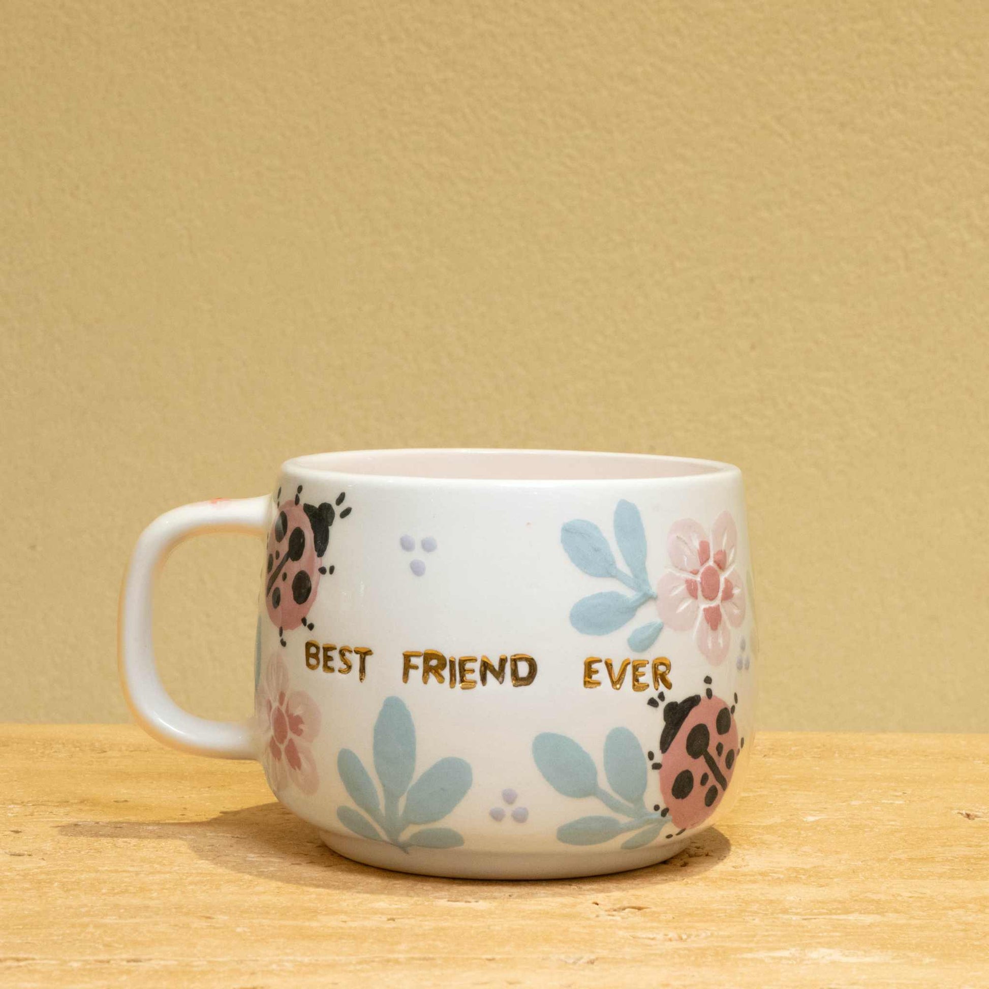 Best Friend Ever personalized gold monogram ceramic mug with floral design.