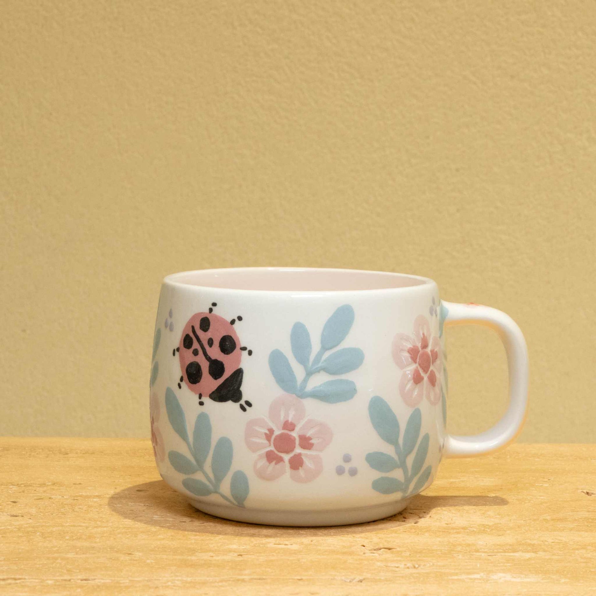 Personalized gold monogram ceramic mug with floral design, perfect for best friends.
