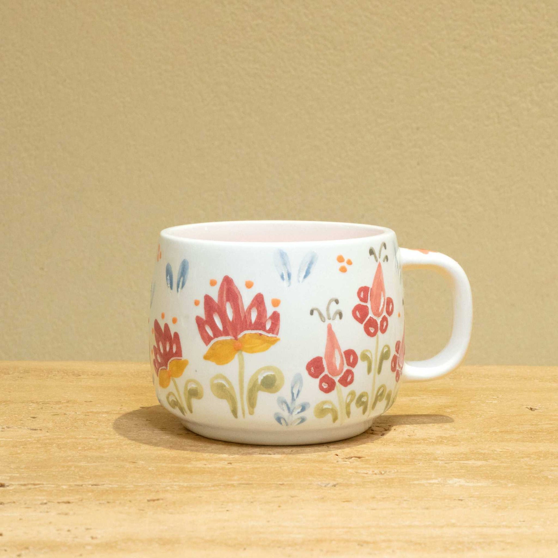 Personalized ceramic mug with gold Arabic monogram "Best Wife In The World" and floral design.