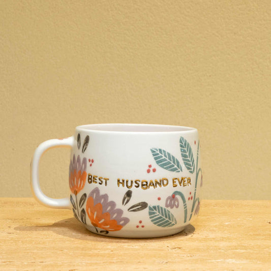 Personalized gold monogram ceramic mug with "Best Husband Ever" and floral design.