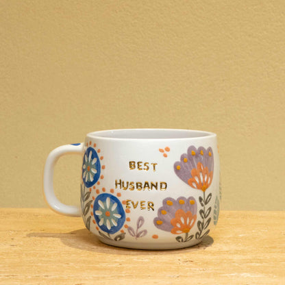 Personalized ceramic mug with gold "Best Husband Ever" text and floral design.