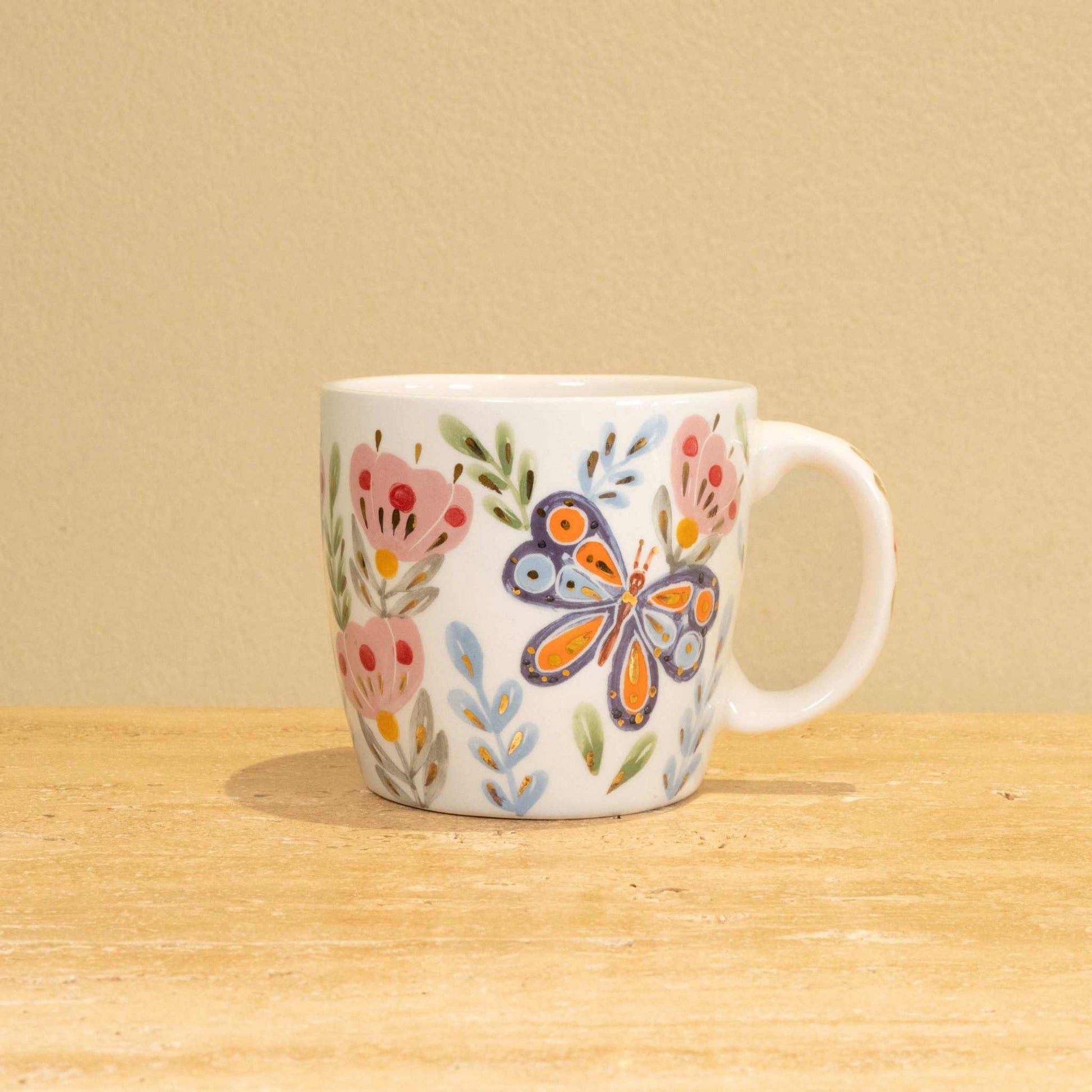 Custom handmade ceramic mug with gold-plated initial "G" and floral design.