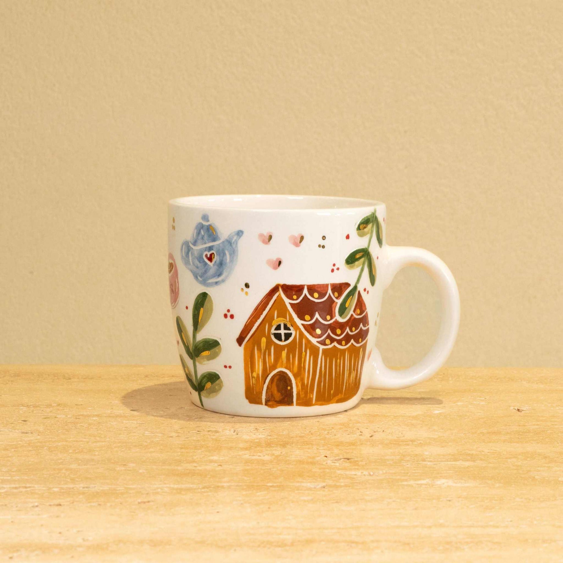 Custom handmade ceramic mug with gold-plated initial "G" and floral design.