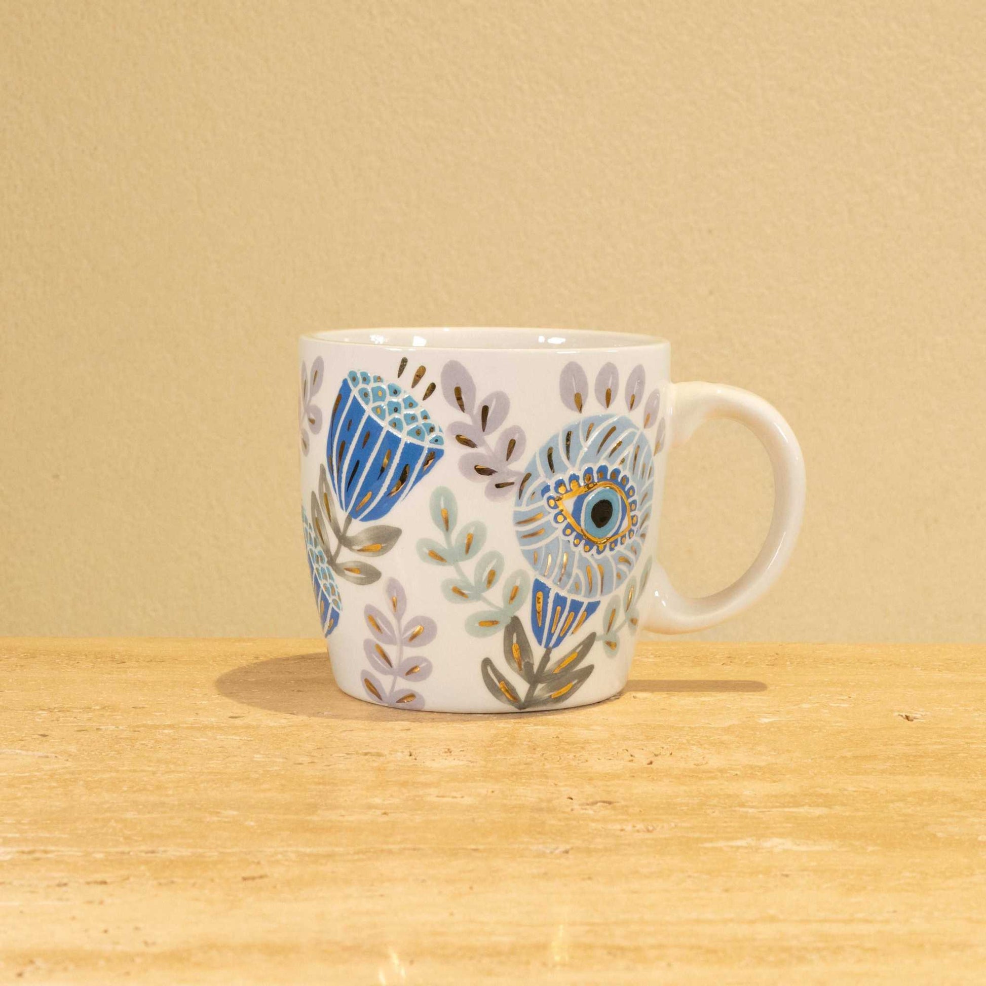 Custom handmade ceramic mug with gold-plated initial "G" and floral design.