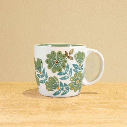 Custom handmade ceramic mug with gold-plated "L" and floral design.
