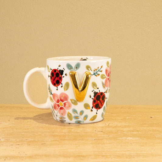 Custom handmade ceramic mug with gold-plated initial "V" and floral design