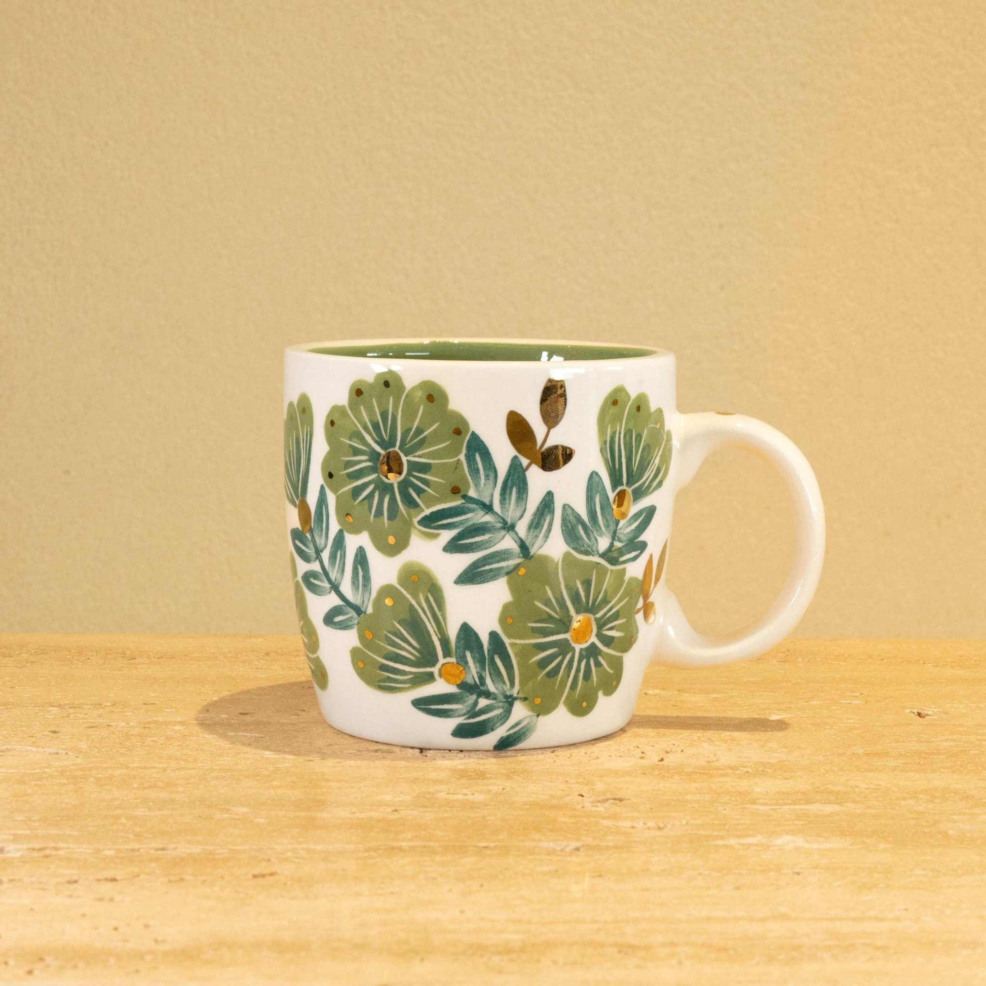Custom handmade ceramic mug with gold-plated "V" and floral design.