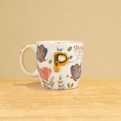 Custom handmade ceramic mug with gold-plated initial "P" and floral design.