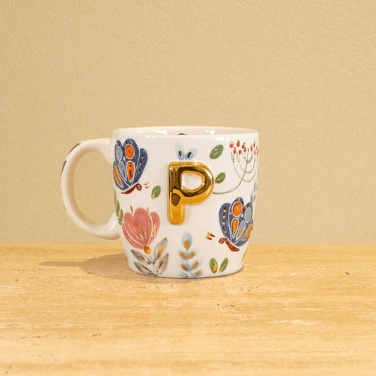 Custom handmade ceramic mug with gold-plated initial "P" and floral design.