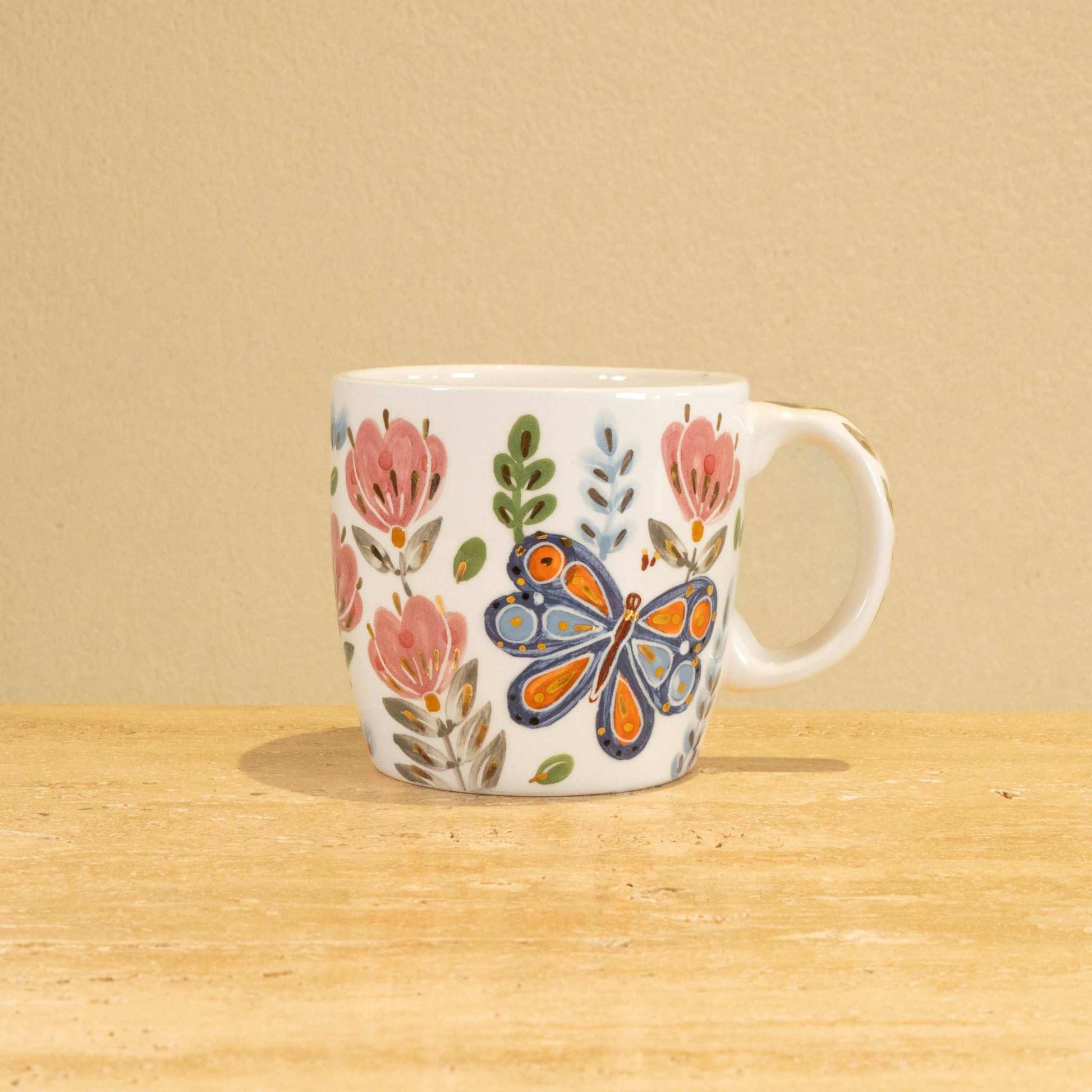 Custom handmade ceramic mug with gold-plated initial "P" and floral design.