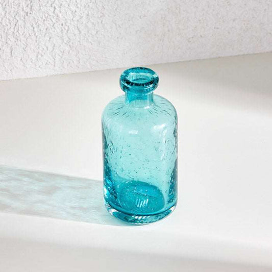 Apothecary glass vase in serene blue hue, perfect for floral display or standalone decor.