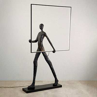 Walking sculpture lamp with square frame, black finish, modern artistic design.
