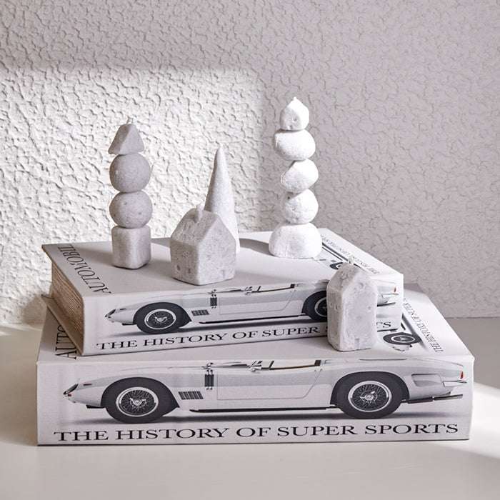 Rock Balancing White Candle with sculptural design on books, enhancing minimalist decor.