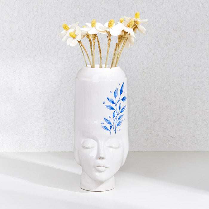 Ceramic handmade girl's face pot with floral design, perfect for plants or decorative use.