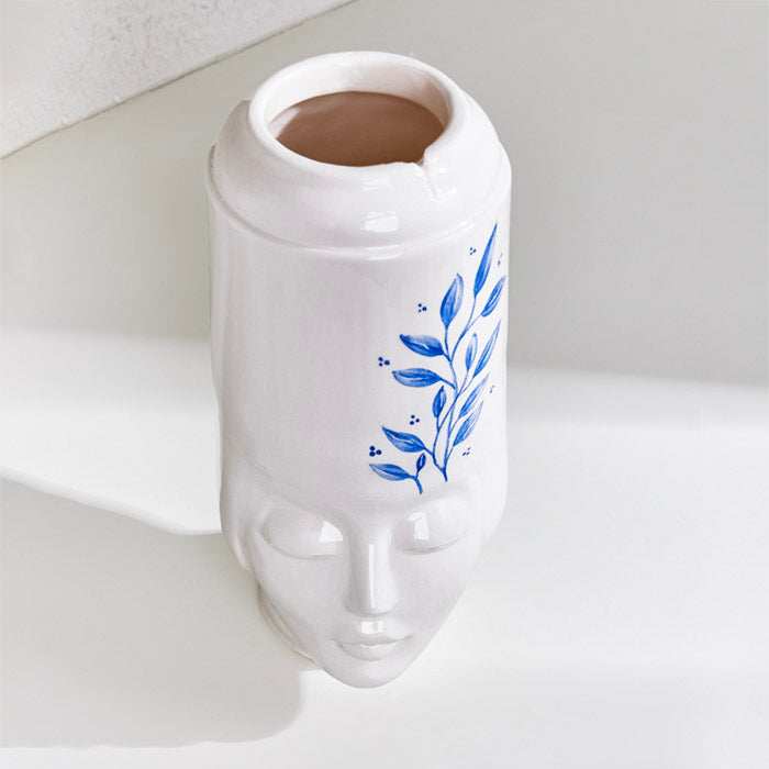 Ceramic handmade girl face pot for plants and decoration.