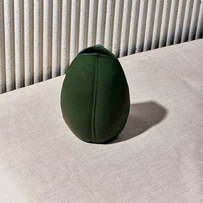 Botany Ceramic Decorative Object with green leaf-inspired texture on a table.
