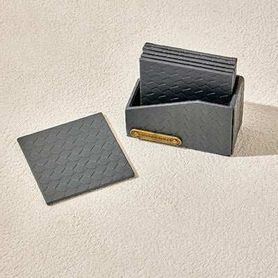 COASTER LEATHER gray set with woven texture in holder, perfect for protecting surfaces while adding a stylish touch to your décor.