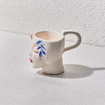 Ceramic handmade mug with sculpted face design from Girl Collection, featuring artistic hand-painted details.