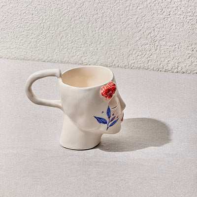 Ceramic handmade mug with sculpted face and hand-painted details from the Girl Collection.