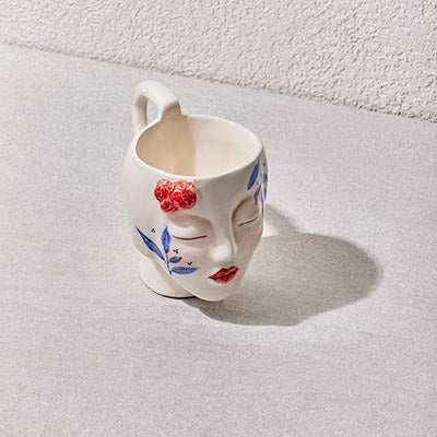Ceramic handmade mug with sculpted face and hand-painted details from Girl Collection.