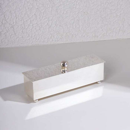 Silver storage box with slanted lid and spherical handle, sleek and minimalist design for luxury home or office use.