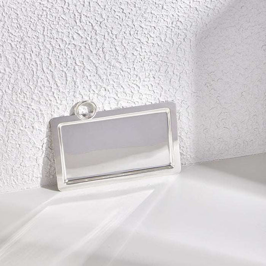 Silver tray with ring handle, 23x31cm, sleek polished metal design.